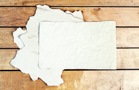 Stack of old paper sheets on a wooden tableの写真素材