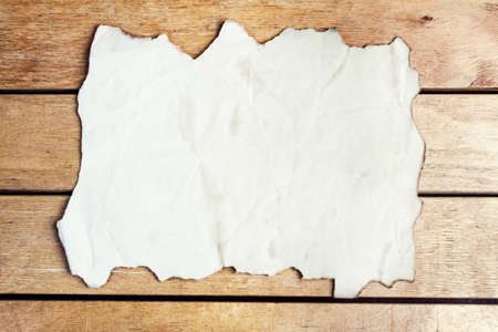 Blank old paper sheet on wooden tableの写真素材