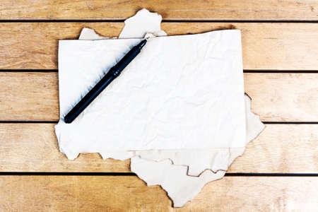 Blank old paper sheets on wooden tableの写真素材