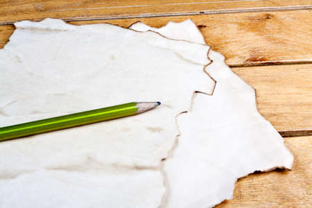 Blank old paper sheet with pencil on old wooden tableの写真素材