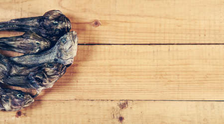 Dry goby fishes on old wooden tableの写真素材