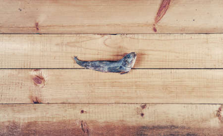 Dry goby fish on old wooden tableの写真素材