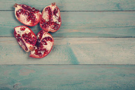 Parts of pomegranate on wooden backgroundの写真素材
