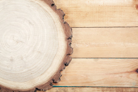 Round board on old wooden tableの写真素材