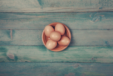 Raw, fresh chicken eggs on wooden background