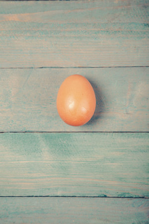 Raw chicken egg on wooden background