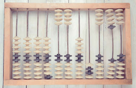 Old vintage retro abacus on wooden white backgroundの写真素材