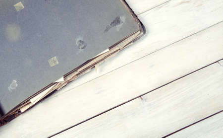 Old opened photo album on wooden backgroundの写真素材