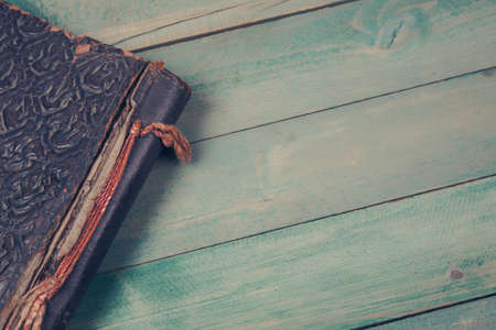 Old photo album on dark green wooden backgroundの写真素材