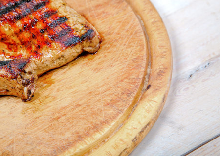 Grilled pork meat on wooden boardの写真素材