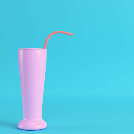 Cocktail glass with straw on bright blue background in pastel colors. Minimalism concept. 3d renderの写真素材