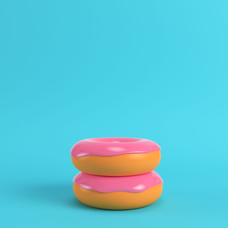 Two donuts with pink glaze on bright blue background in pastel colors. Minimalism concept. 3d render