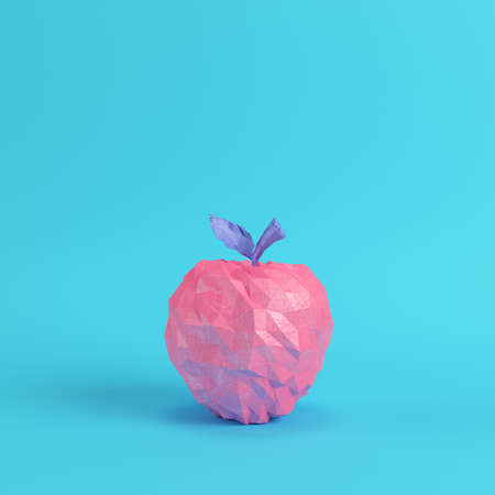 Low poly pink apple on bright blue background in pastel colors. Minimalism concept. 3d renderの写真素材
