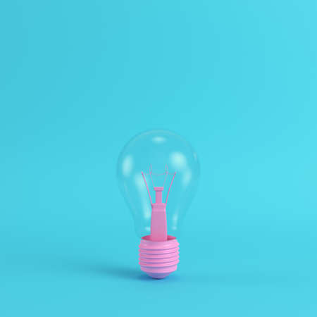 Pink light bulb on bright blue background in pastel colors. Minimalism concept. 3d renderの写真素材