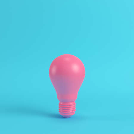 Pink light bulb on bright blue background in pastel colors. Minimalism concept. 3d renderの写真素材