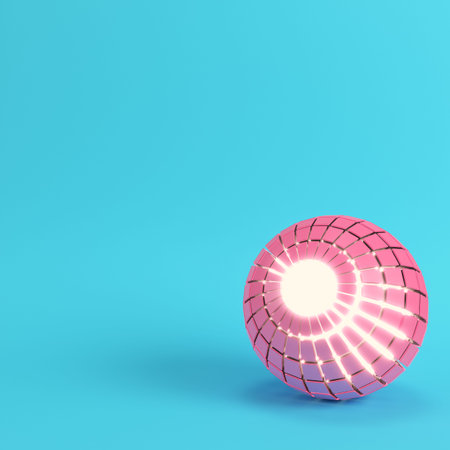 Abstract segmented pink sphere glowing inside on bright blue background in pastel colors with copy...