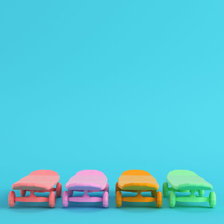 Four colorful scateboards decks on bright blue background in pastel colors. Minimalism concept. 3d renderの写真素材