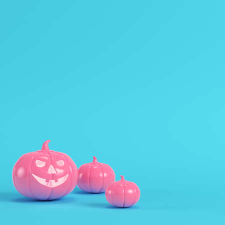 Pink halloween pumpkin, jack o lantern on bright blue background in pastel colors. Minimalism concept. 3d renderの写真素材