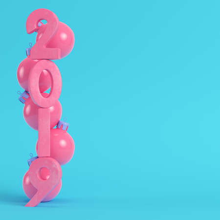 Pink new year 2019 figures with christmas balls on bright blue background in pastel colors. Minimalism concept. 3d renderの写真素材
