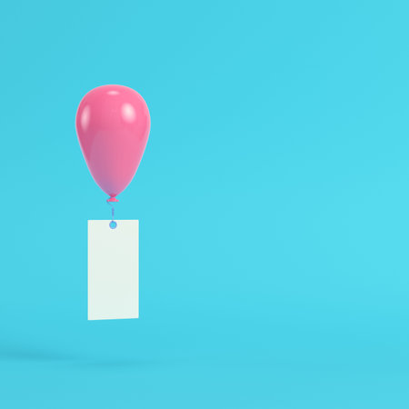 Pink air balloon with blank banner on bright blue background in pastel colors. Minimalism concept....
