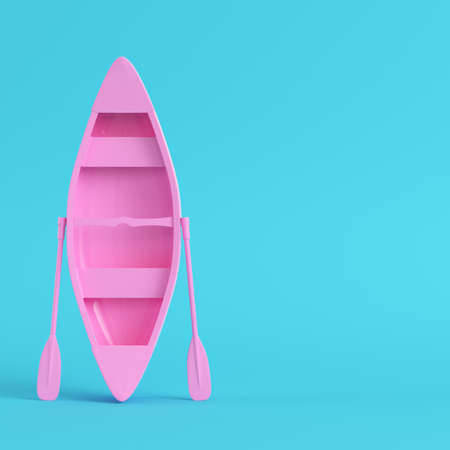 Pink canoe with paddles on bright blue background in pastel colors. Minimalism concept. 3d renderの写真素材