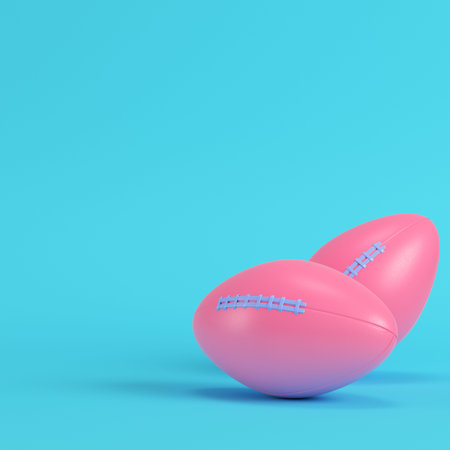 Pink american football ball on bright blue background in pastel colors. Minimalism concept. 3d...