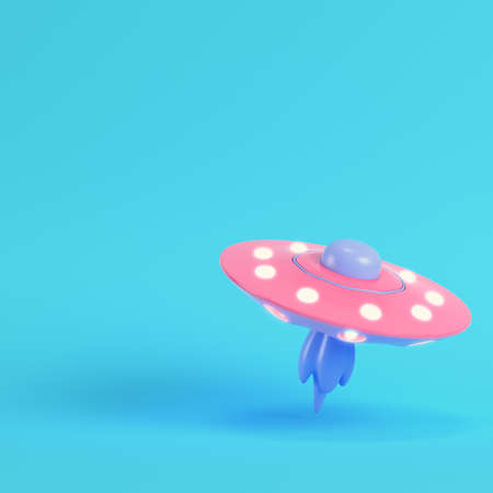 Pink ufo or alien spaceship on bright blue background in pastel colors. Minimalism concept. 3d renderの写真素材