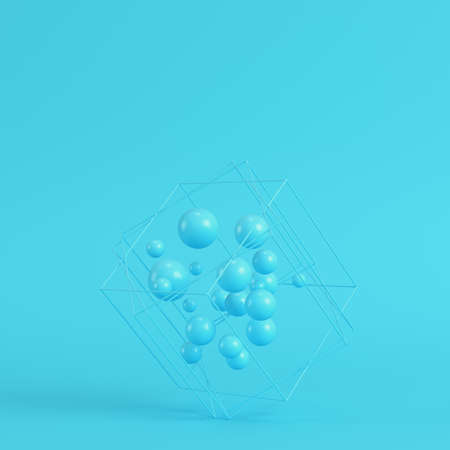 Abstract spheres in wire box on bright blue background in pastel colors. Minimalism concept. 3d renderの写真素材