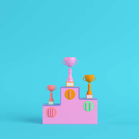 Pedestal with trophy cups on bright blue background in pastel colors. Minimalism concept. 3d renderの写真素材
