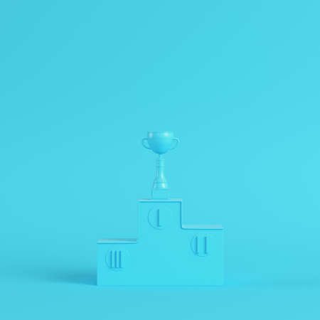 Pedestal with trophy cup on bright blue background in pastel colors. Minimalism concept. 3d renderの写真素材