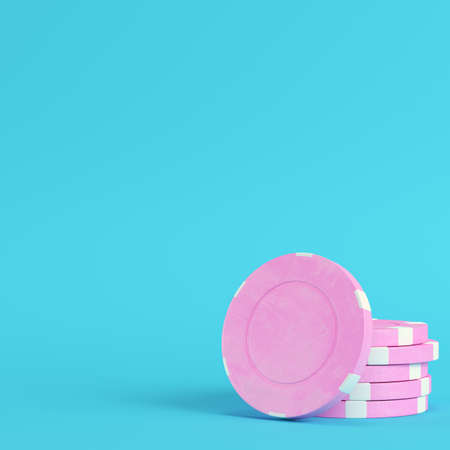 Pink casino chips on bright blue background in pastel colors. Minimalism concept. 3d renderの写真素材