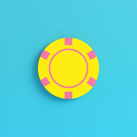 Yellow casino chip on bright blue background in pastel colors. Minimalism concept. 3d renderの写真素材