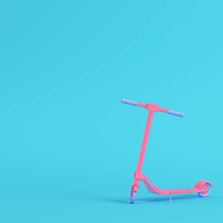 Pink kick scooter on bright blue background in pastel colors. Minimalism concept. 3d renderの写真素材