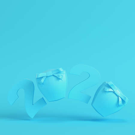 New year 2020 figures with gift boxes on bright blue background in pastel colors. Minimalism concept. 3d renderの写真素材