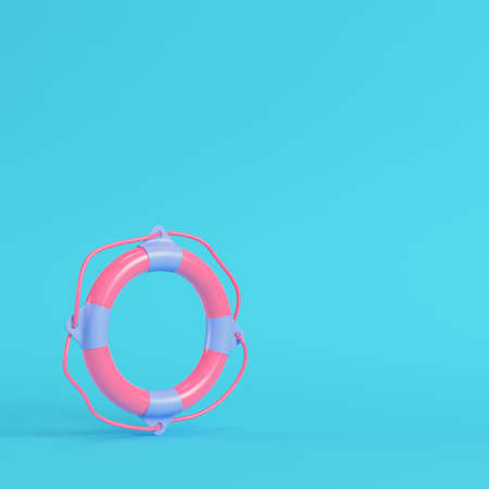 Pink life buoy on bright blue background in pastel colors. Minimalism concept. 3d renderの写真素材
