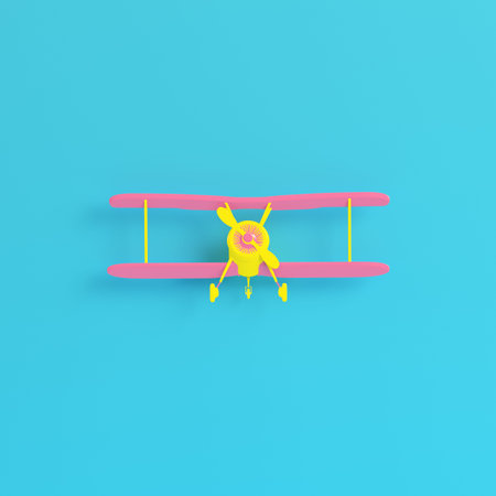 Yellow biplane on bright blue background in pastel colors. Minimalism concept. 3d renderの写真素材