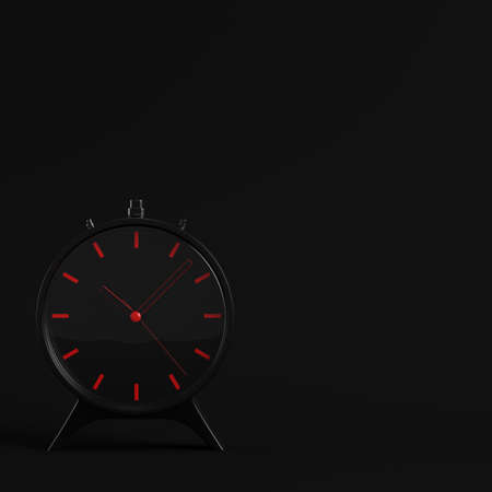 Black alarm clock on dark background. Minimalism concept. 3d renderの写真素材