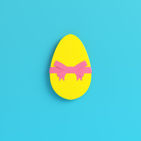 Yellow easter egg with bow on bright blue background in pastel colors. Minimalism concept. 3d renderの写真素材