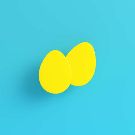 Yellow easter eggs on bright blue background in pastel colors. Minimalism concept. 3d renderの写真素材
