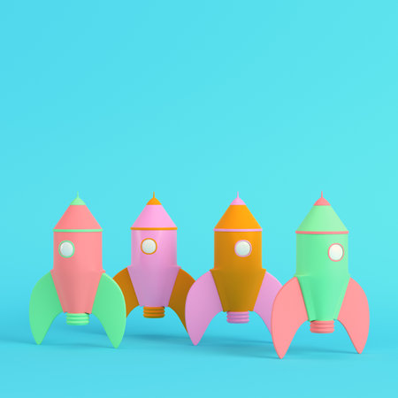 Pink cartoon styled rocket on bright blue background in pastel colors. Minimalism concept. 3d renderの写真素材