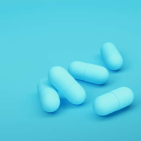 Capsule pills on bright blue background in pastel colors. Minimalism concept. 3d renderの写真素材