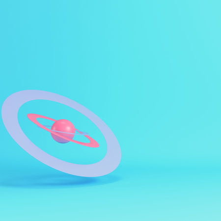 Pink cartoon style planet with rings on bright blue background in pastel colors. Minimalism concept....