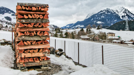Stacked firewood in winter at rural village in Switzerlandの写真素材