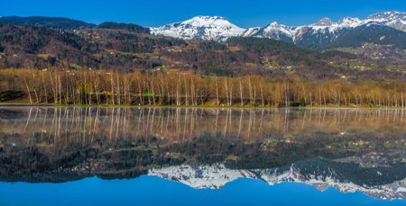 Aravis Mountain Range and its reflection on the surface of Lac du Passy, Passy, Franceの写真素材