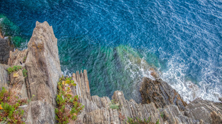 Rocks and cliff off Manarola coast and the Mediterranean sea in Cinque Terre, Liguria, Italy