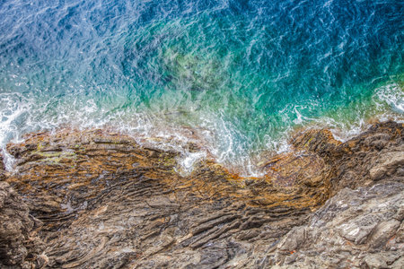 Rocks and cliff off Manarola coast and the Mediterranean sea in Cinque Terre, Liguria, Italy