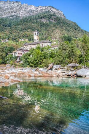 A church in the Swiss Italian village of Levertezzo with a mountain in the backgroundの写真素材