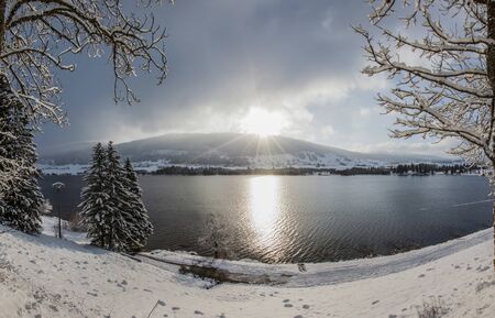 Lac des Rousses or Lake Rousses, in Jura Mountain range in winter の写真素材
