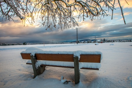 A bench in winter in rural Switzerlandの写真素材