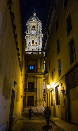 December 13th, 2012, Malaga, Spain. Malaga street scene at night with Malaga Cathedral bell tower in the background.のeditorial素材